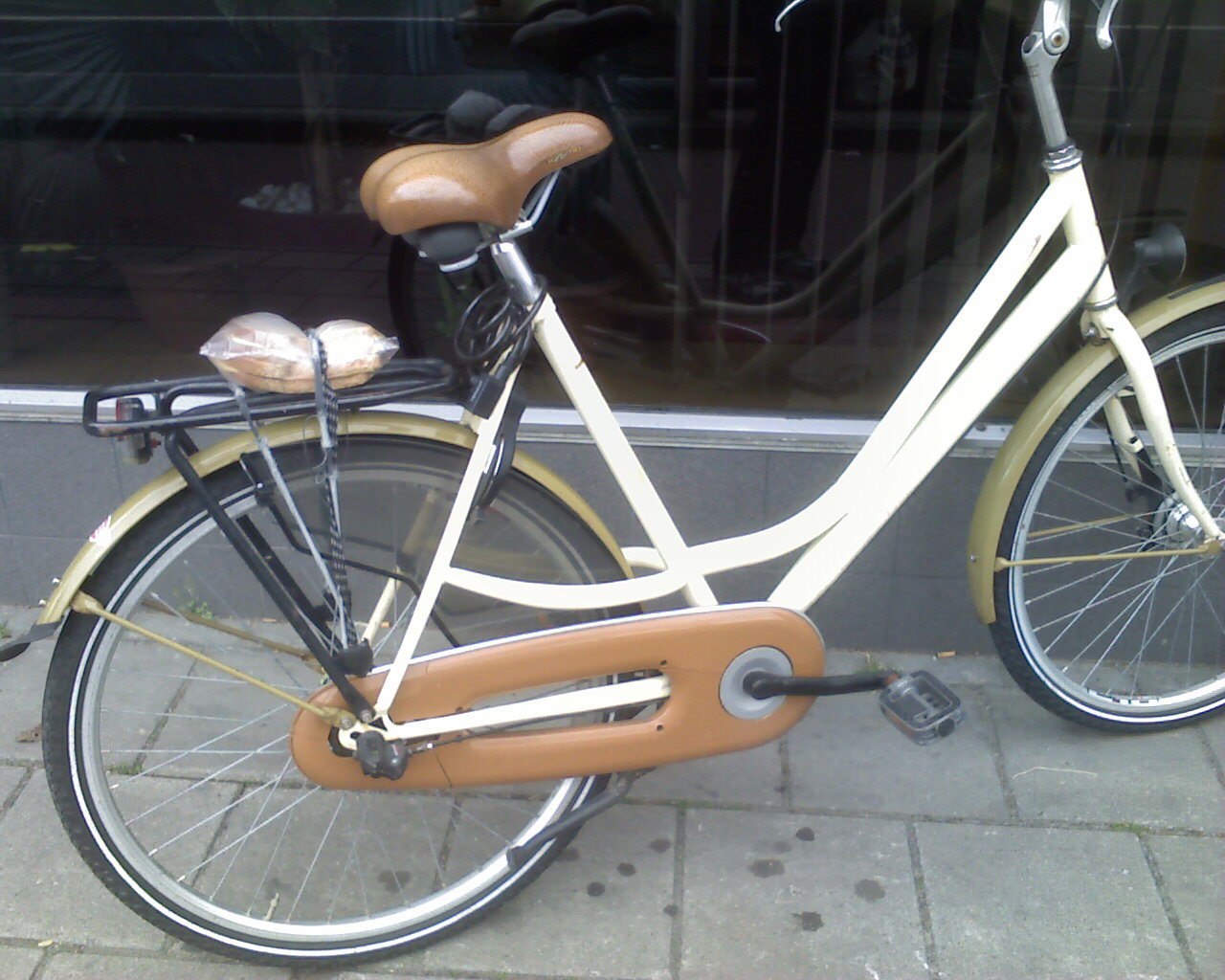 Picture showing a sandwich tied to a bicycle luggage rack